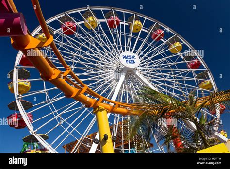 Roller coaster and ferris wheel at Santa Monica Pier, California Stock ...