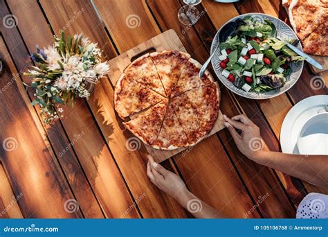 Woman Setting the Pizza on Table for Dinner Stock Photo - Image of brunch, meal: 105106768