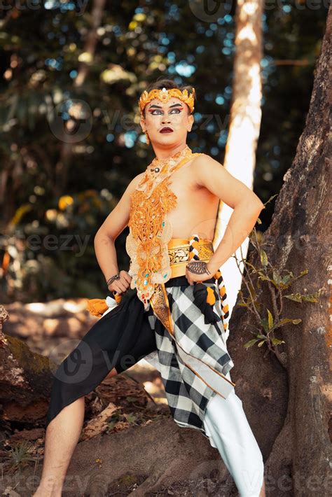 Balinese dancer performs the dance in golden costume and golden crown ...