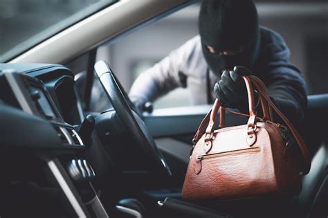 Premium Photo | Thieves are stealing wallets in the car