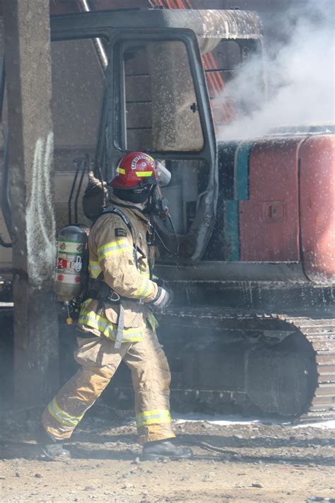 Firefighters stop flames from burning excavator from reaching loaded rail car | KVAL