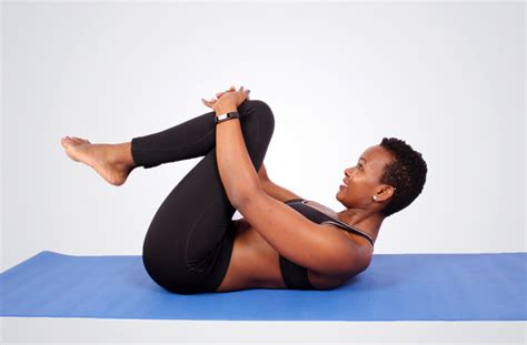 Fit Woman Doing The Supine Lower Back Stretch on Yoga Mat