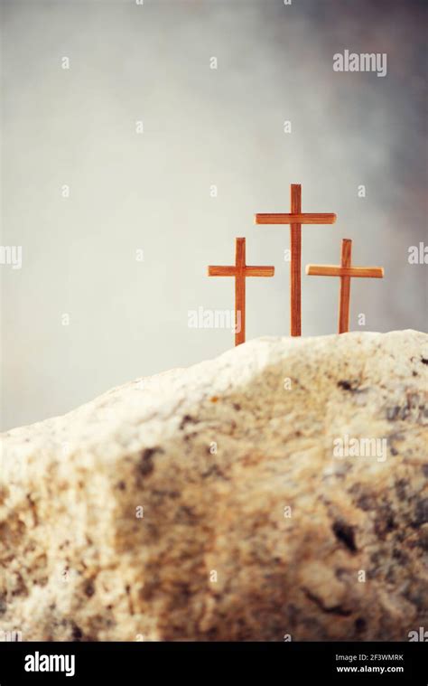 Three wooden cross on Calvary hill, grey background. Crucifixion ...