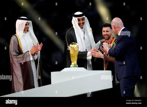 The Emir of Qatar, Sheikh Tamim bin Hamad Al Thani presents Argentina captain Lionel Messi with ...