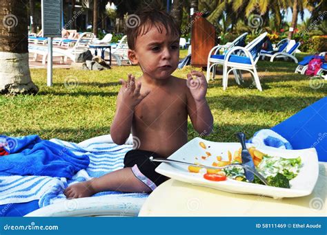 Toddler eating chips stock image. Image of eastern, outdoors - 58111469