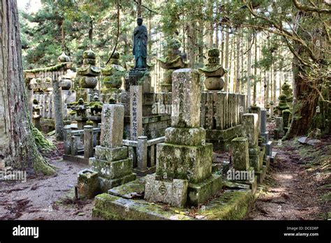 Japan, Mount Koya, Koyasan graveyard, Okunoin, priest statue on large tomb, torii gate and ...