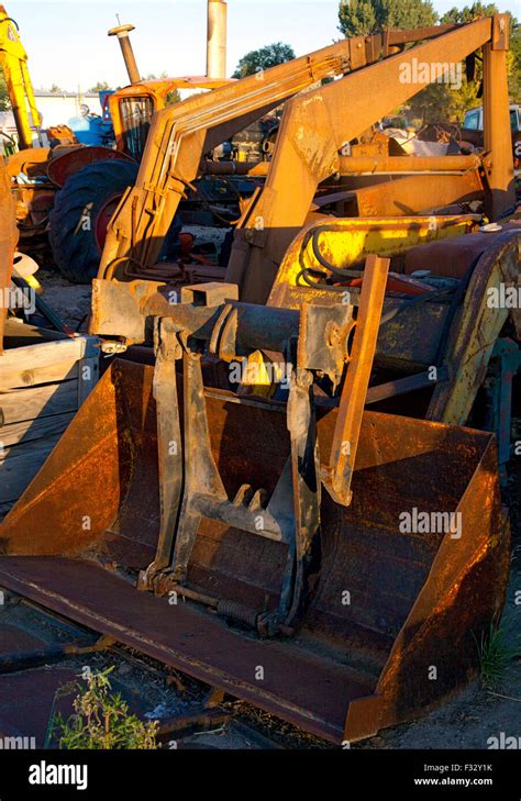 Rusted farm tractor parts in junkyard at sunset,US,2015 Stock Photo - Alamy