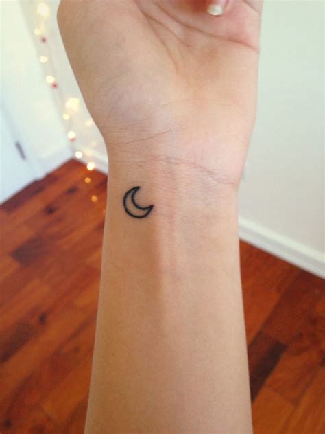 Black small crescent moon tattoo on the wrist - Tattoogrid.net