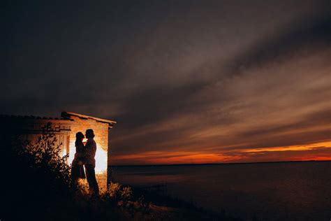 Silhouette of Couple Hugging at Sunset · Free Stock Photo