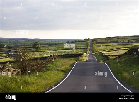 Paved road in rural landscape Stock Photo - Alamy