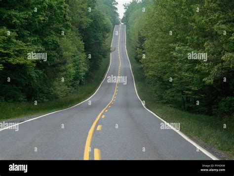 Two lane country road extends over the next hill, Virginia, USA Stock Photo - Alamy