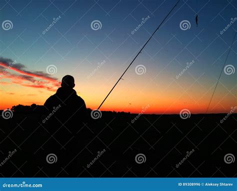 Silhouette of a Man Fishing at Sunset Stock Photo - Image of casting ...