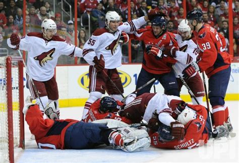 Photo: Coyotes and Capitals players dog pile at the goal in Washington ...