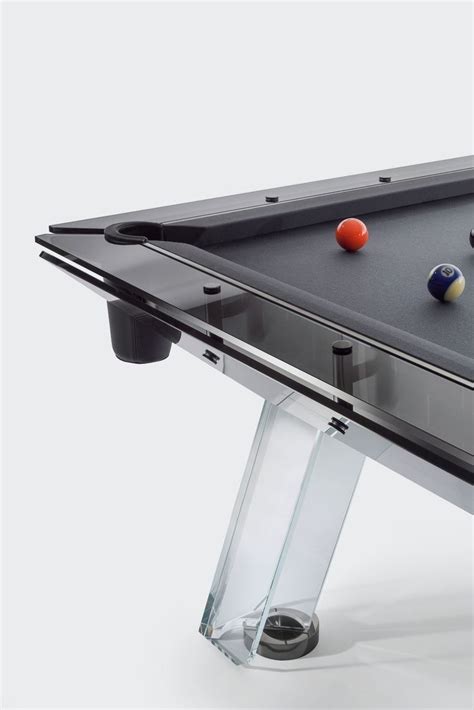 a pool table with two balls on it and one ball resting on the back end