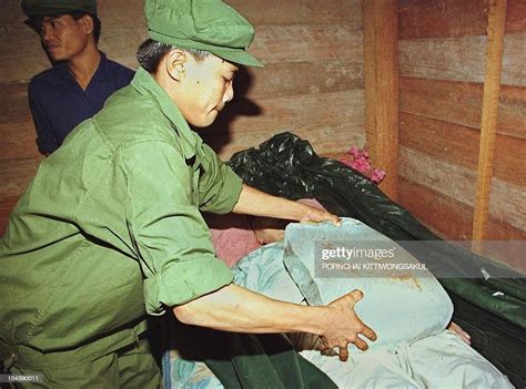 A Khmer Rouge soldier puts a block of ice on the body of his former... News Photo - Getty Images