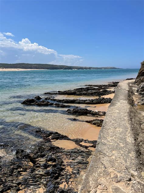 Water at Seashore with Rocks · Free Stock Photo