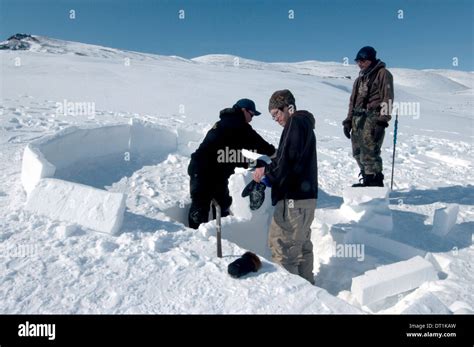 Inuit elder teaches igloo building to young men from the community of ...