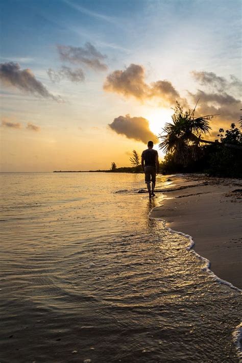 Man Walking Alone on Beach at Sunrise Stock Photo - Image of morning ...