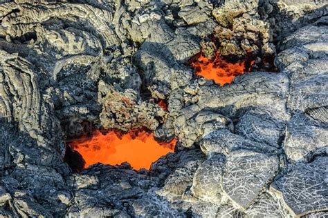 Molten lava glowing near dried lava - Stock Photo - Dissolve