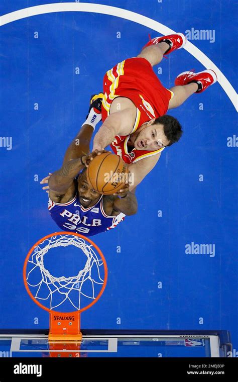 Philadelphia 76ers' Dwight Howard, bottom, goes up for a dunk past ...