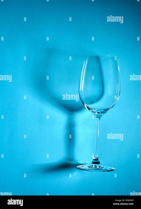 Empty wine glasses arranged on blue background with shadow. Top view or flat lay Stock Photo - Alamy