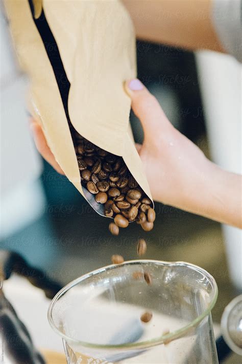 "Pouring Whole Coffee Beans Into A Cup." by Stocksy Contributor "Lucas Saugen Photography LLC ...
