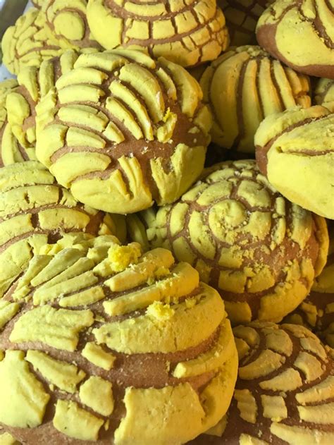 a pile of yellow and brown cookies sitting on top of each other