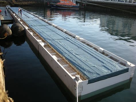 The MCMV pontoons being hinged together before the concrete is pumped to stitch the deck ...