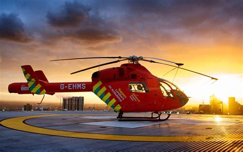 Red helicopter at city sunset wallpaper | aircraft | Wallpaper Better