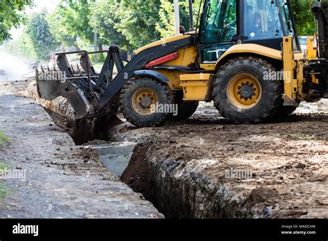 Excavator while working Stock Photo - Alamy