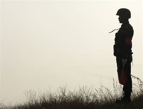 File:A Chinese soldier with the People's Liberation Army waits to assist with American and ...