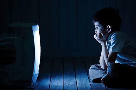 Boy watching TV at night - Mom Blog Society