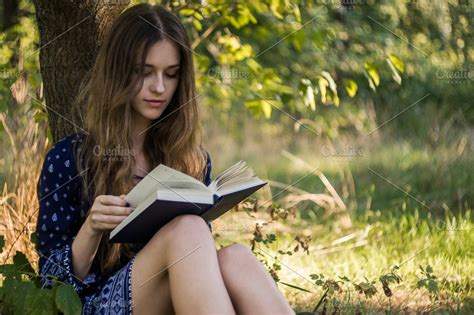 Girl reading a book in summer forest | High-Quality People Images ~ Creative Market