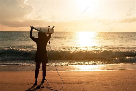 Surfer Woman Silhouette Carrying Surfboards At Sunset Beach Photo ...