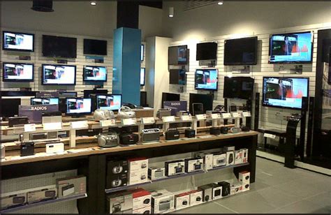 TV wall and playtables, Currys PC World Westfield Stratford | Electronics store design, Home ...