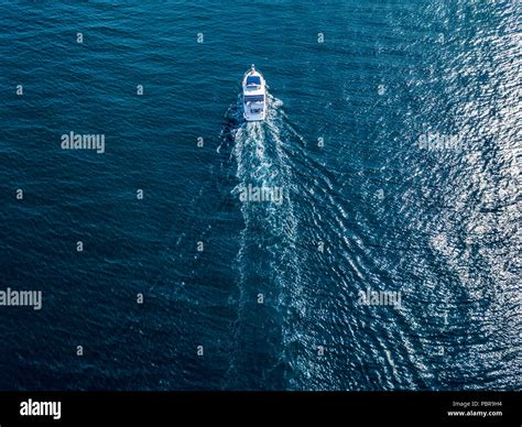 aerial top view of isolated fast speed white motor boat ship on a sea ...