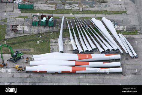 Aerial photo of giant wind turbine blades lying in a row on the ground ...