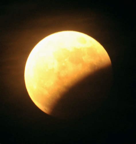 Partial lunar eclipse in the Pacific: a bite out of the moon (PHOTOS ...