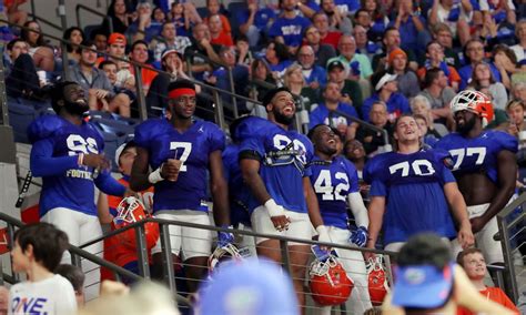 Florida football players watch Gators basketball game in full pads