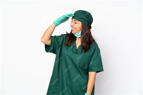 Premium Photo | Surgeon woman in green uniform on white smiling a lot