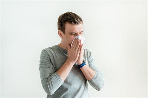 Premium Photo | Sneezing man in handkerchief blowing wiping running nose isolated on white ...