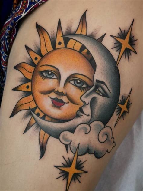 a sun and moon tattoo on the back of a woman's thigh, with stars around it