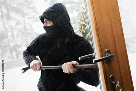 house robbery - robber trying open door with crowbar Stock Photo | Adobe Stock