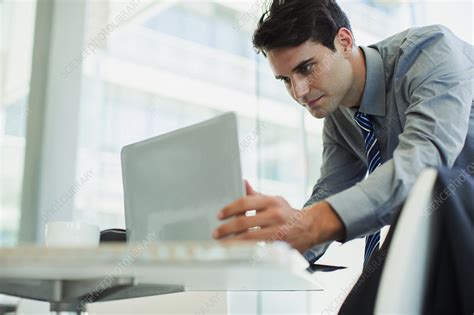 Businessman using laptop in office - Stock Image - F030/8024 - Science Photo Library