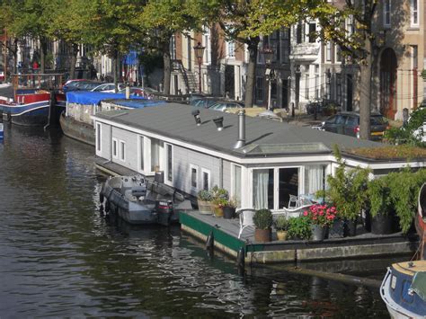 several boats are docked in the water near houses