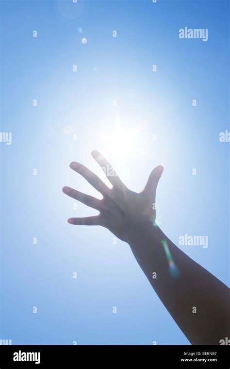 Woman's hand reaching sun Stock Photo - Alamy