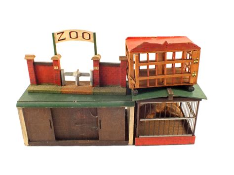 A wooden toy zoo including cages and lead animals