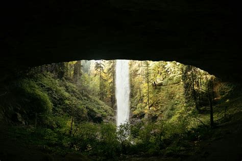 A view of a waterfall from inside a cave photo – Free Nature Image on Unsplash