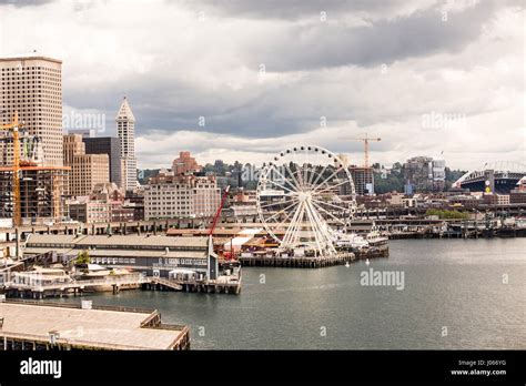 Seattle waterfront with boats, freight, and ferris wheel Stock Photo ...