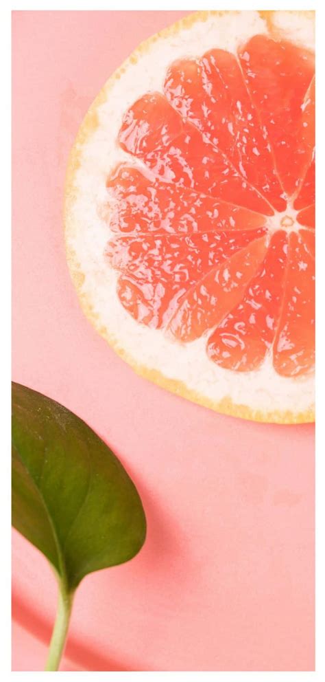 Download Refreshing Pink Grapefruit Slices Wallpaper | Wallpapers.com